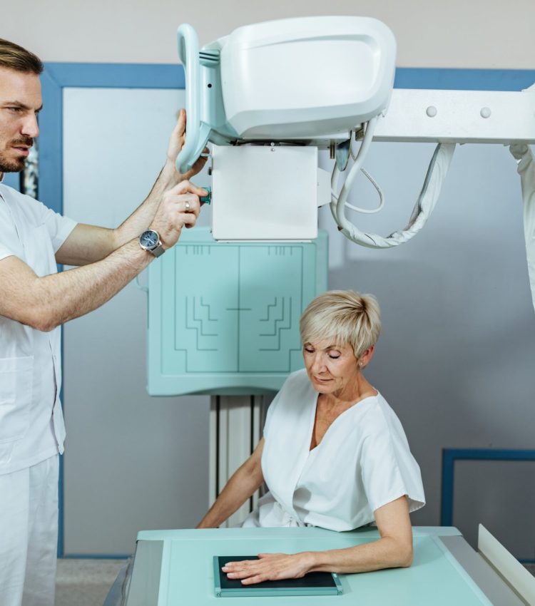 medical-technician-starting-xray-scan-mature-patient-s-hand-medical-clinic-min